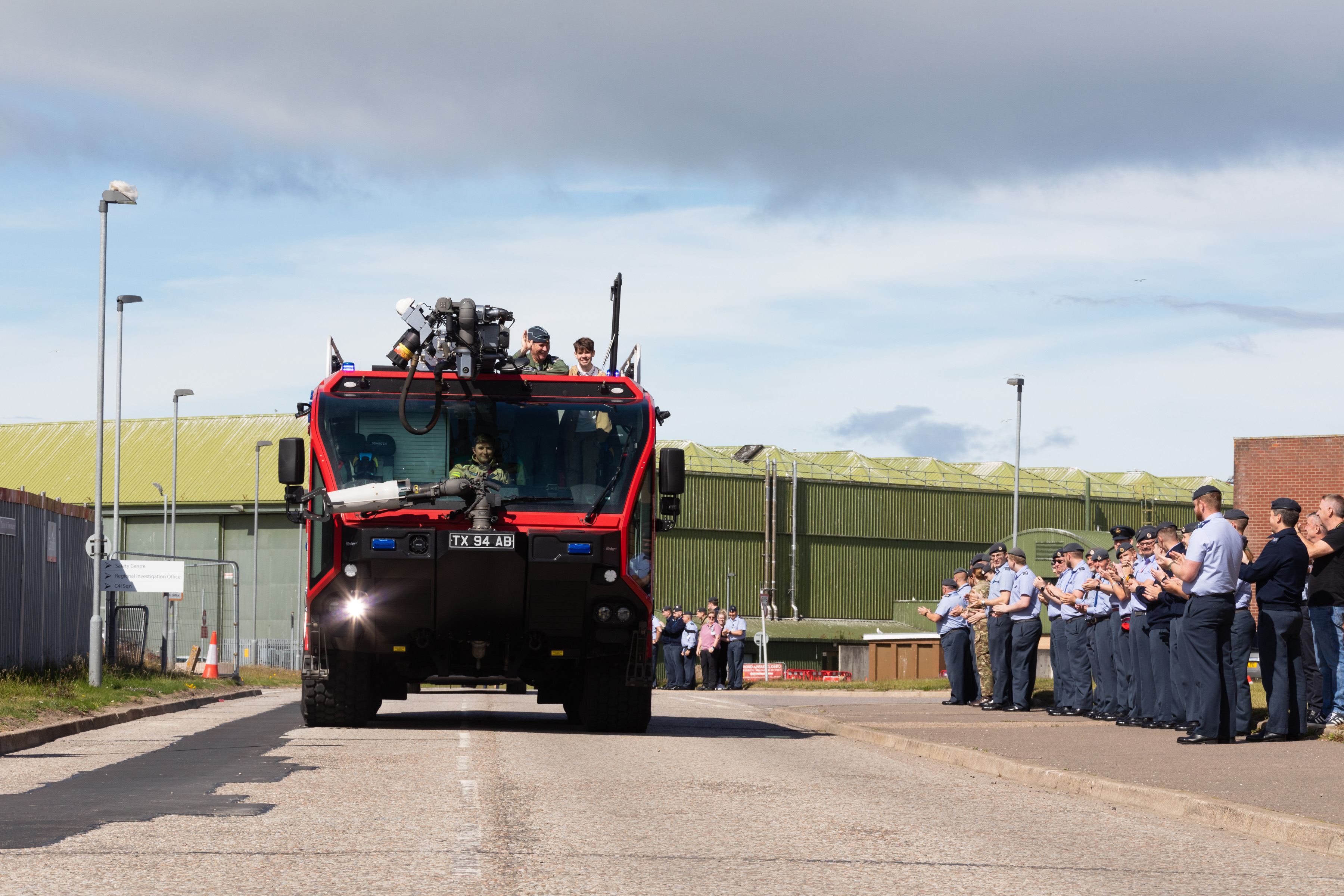 Image shows aviators clapping vehicle as it drives by.